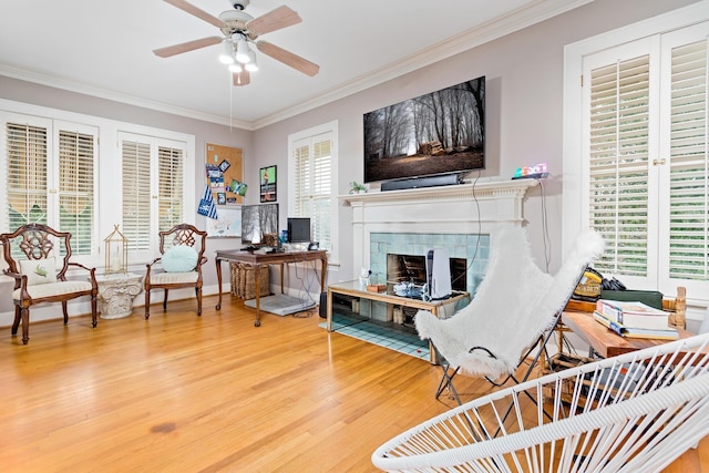 interior space featuring ceiling fan, a fireplace, and a wealth of natural light