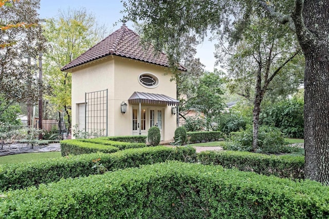 mediterranean / spanish-style home with french doors