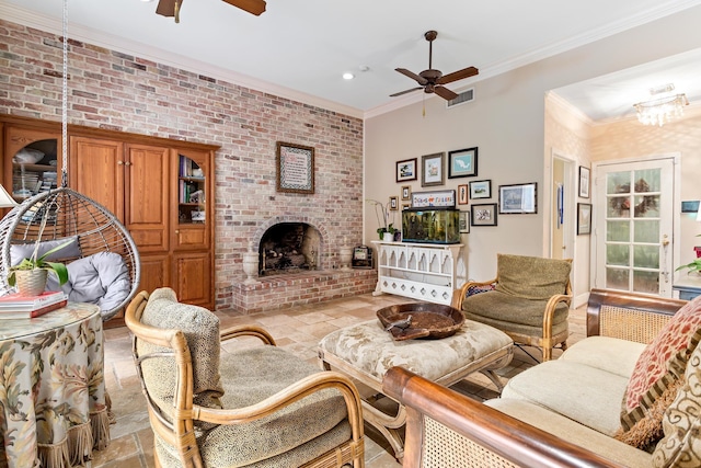 living room with ceiling fan, crown molding, brick wall, and a brick fireplace