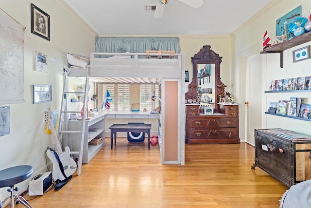 bedroom with light hardwood / wood-style flooring, ceiling fan, and ornamental molding