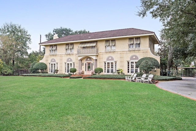 view of front of home with a front yard and french doors