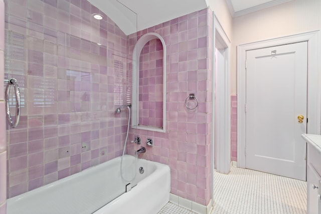 bathroom with crown molding, tile patterned flooring, and tiled shower / bath