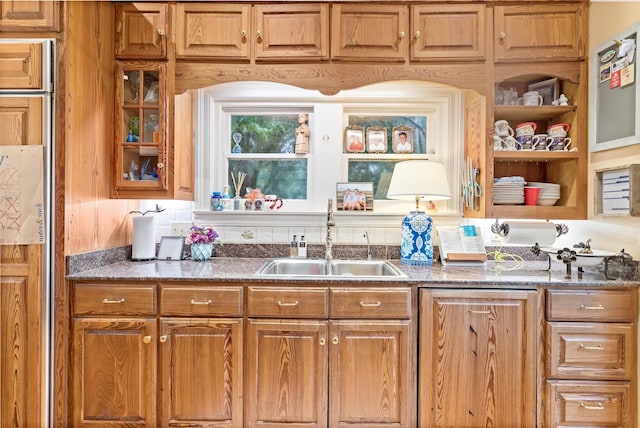 kitchen with sink and dark stone counters