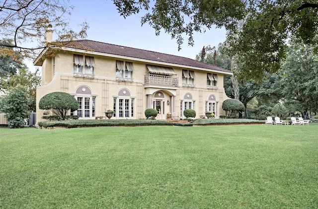 view of front of property with french doors and a front lawn