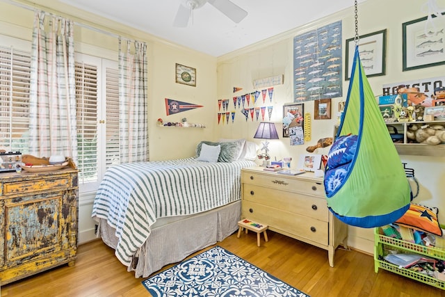 bedroom with wood-type flooring, ceiling fan, and crown molding