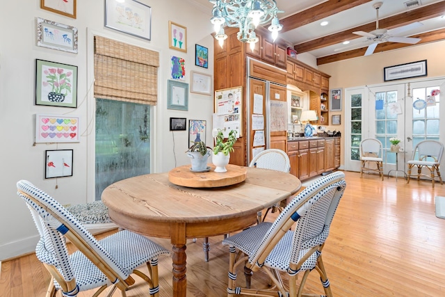 dining room featuring ceiling fan, beam ceiling, light wood-type flooring, and french doors