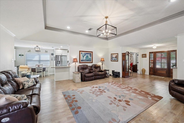 2519 Ridgewood Ln, Nederland, TX 77627 - living area with a chandelier, a tray ceiling, ornamental molding, light wood-style floors, and recessed lighting