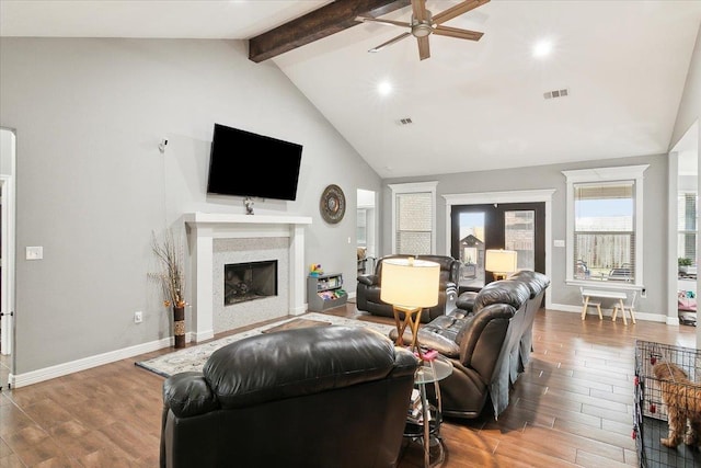 living room with ceiling fan, high vaulted ceiling, and beam ceiling