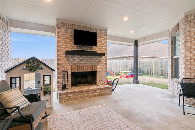 view of patio with an outdoor brick fireplace and an outdoor structure