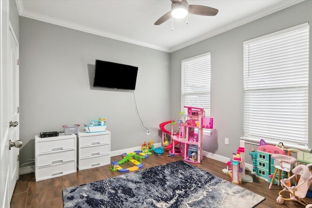 playroom featuring crown molding, dark hardwood / wood-style floors, and ceiling fan