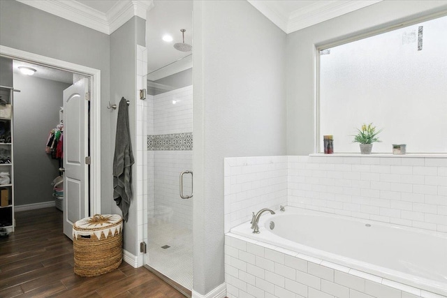 bathroom with crown molding, wood-type flooring, and plus walk in shower