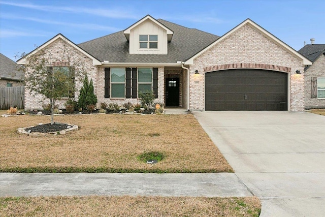 view of front of home with a garage and a front yard