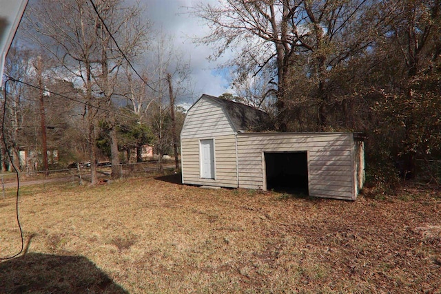 view of outbuilding featuring fence and an outdoor structure
