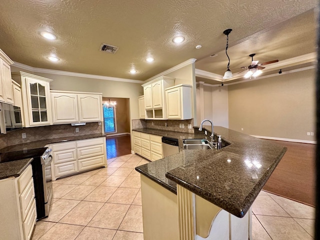 kitchen with light tile patterned floors, a peninsula, stainless steel appliances, and a sink