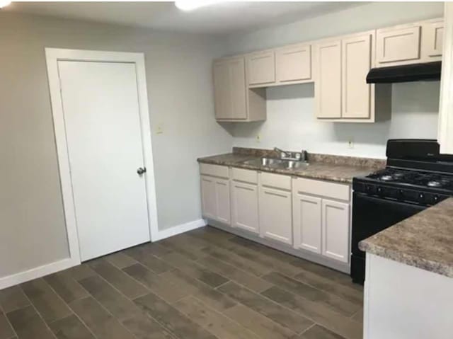 kitchen featuring white cabinets, sink, and black range with gas cooktop