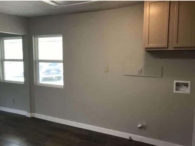 washroom with cabinets, hookup for a washing machine, and dark wood-type flooring