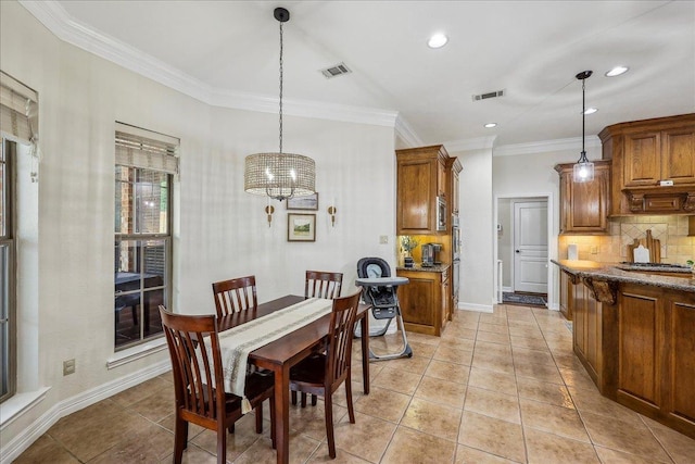 dining room with baseboards, ornamental molding, a notable chandelier, and visible vents