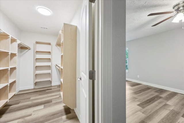 42252 State Highway 87, Orange, TX 77632 - spacious closet featuring ceiling fan and wood finished floors