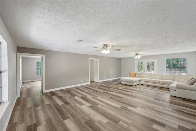 42252 State Highway 87, Orange, TX 77632 - living area featuring ceiling fan, wood finished floors, baseboards, and a textured ceiling