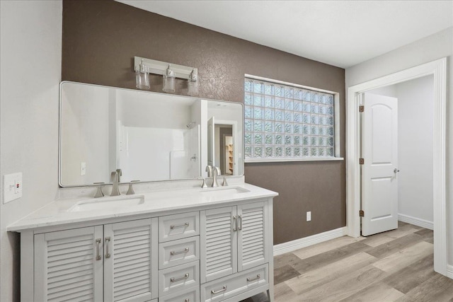 42252 State Highway 87, Orange, TX 77632 - full bath with wood finished floors, double vanity, a shower, and baseboards