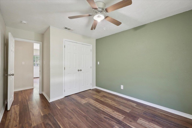 664 W Tram Rd, Vidor, TX 77662 - unfurnished bedroom featuring dark wood-style floors, baseboards, a closet, and ceiling fan