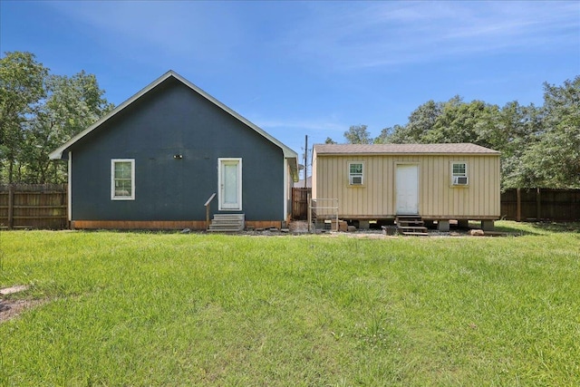 664 W Tram Rd, Vidor, TX 77662 - rear view of house with entry steps and an outbuilding