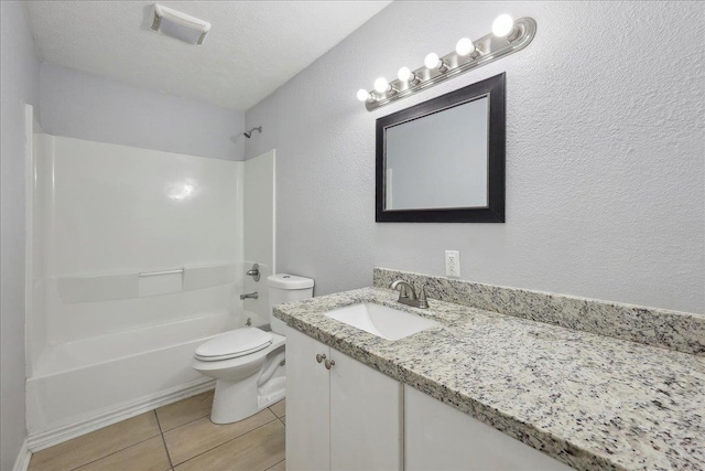 664 W Tram Rd, Vidor, TX 77662 - full bathroom featuring toilet, tile patterned floors, vanity, shower / bathtub combination, and a textured wall