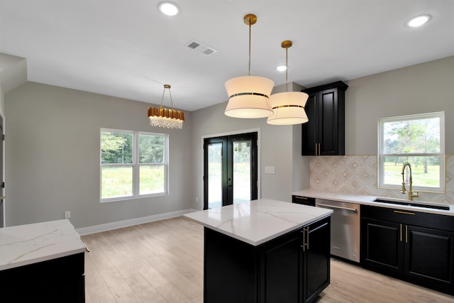 kitchen featuring dishwasher, a center island, hanging light fixtures, and sink