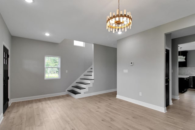 interior space with an inviting chandelier and light hardwood / wood-style flooring