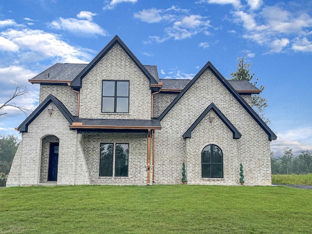 french country style house featuring a front yard