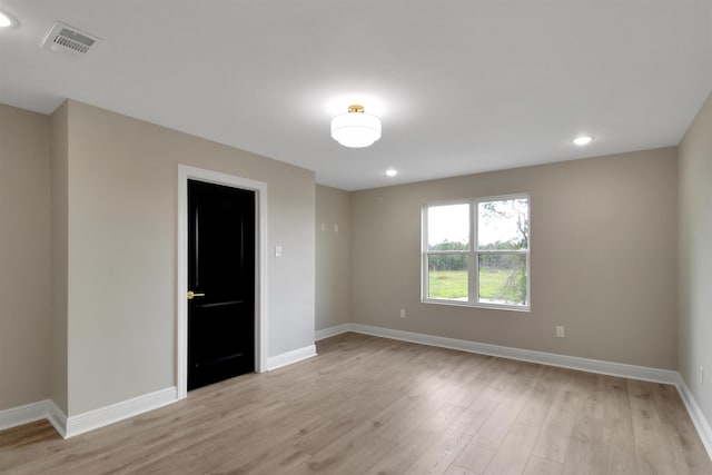 unfurnished room with light hardwood / wood-style flooring