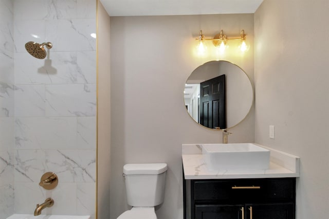 full bathroom featuring vanity, toilet, and tiled shower / bath combo