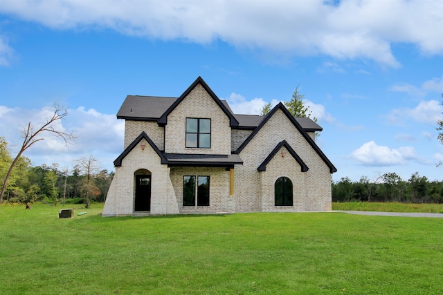 french provincial home with a front lawn