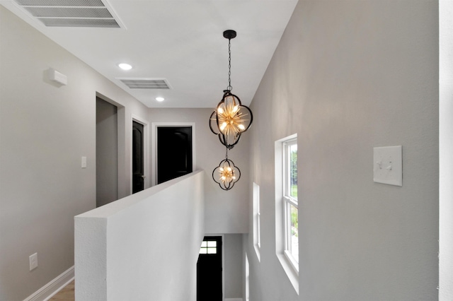 hallway featuring a notable chandelier