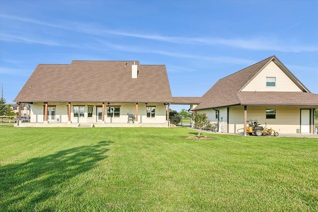 rear view of property with a yard