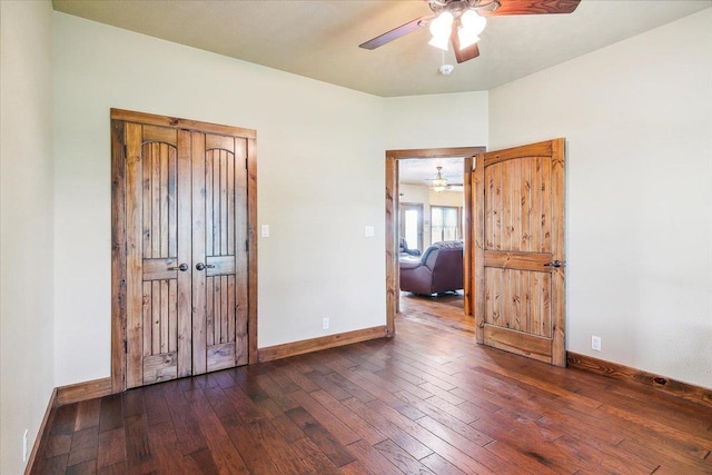 unfurnished bedroom with dark hardwood / wood-style floors and ceiling fan