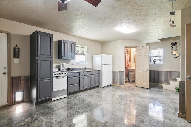 kitchen featuring sink, gray cabinetry, white refrigerator, range, and a textured ceiling