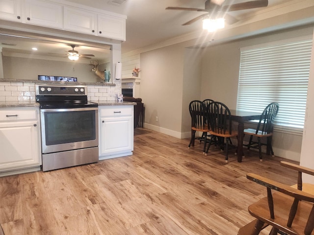 10848 Sandy Ln, Beaumont, TX 77705 - kitchen featuring stainless steel range with electric cooktop, ceiling fan, decorative backsplash, ornamental molding, and white cabinets