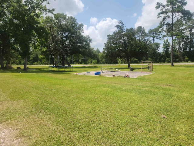 10848 Sandy Ln, Beaumont, TX 77705 - surrounding community with a trampoline, a lawn, and view of scattered trees