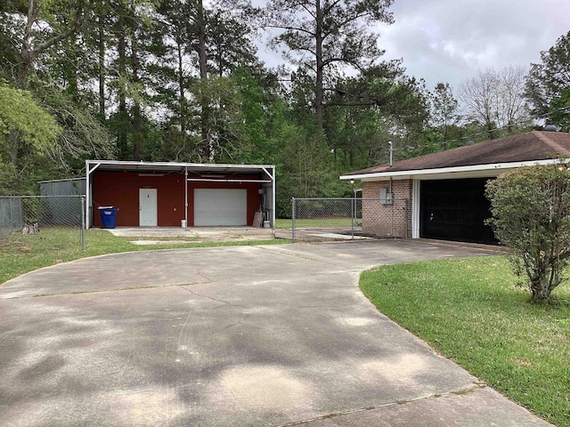 garage featuring a detached garage and fence