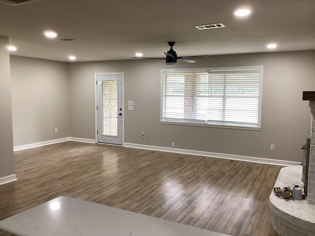 foyer with dark wood-style flooring, visible vents, a brick fireplace, recessed lighting, and a ceiling fan