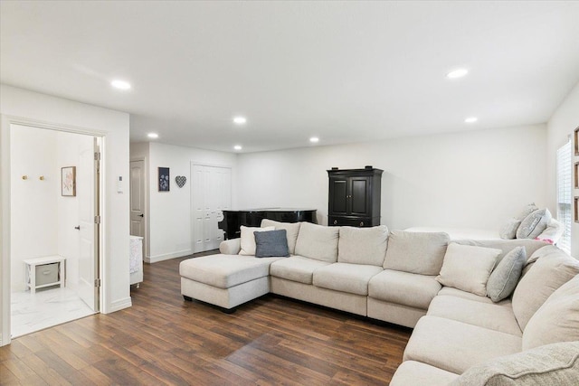 living area featuring dark wood-type flooring, baseboards, and recessed lighting
