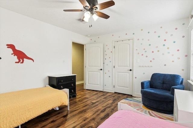 bedroom with wood finished floors, ceiling fan, baseboards, and visible vents