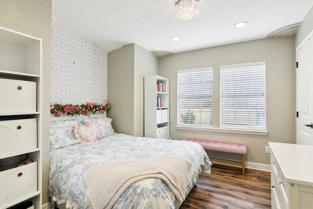 bedroom with baseboards, recessed lighting, and dark wood finished floors