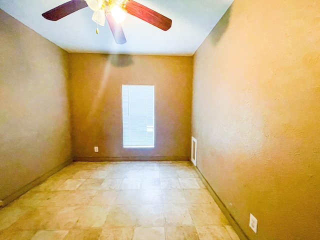 spare room with ceiling fan