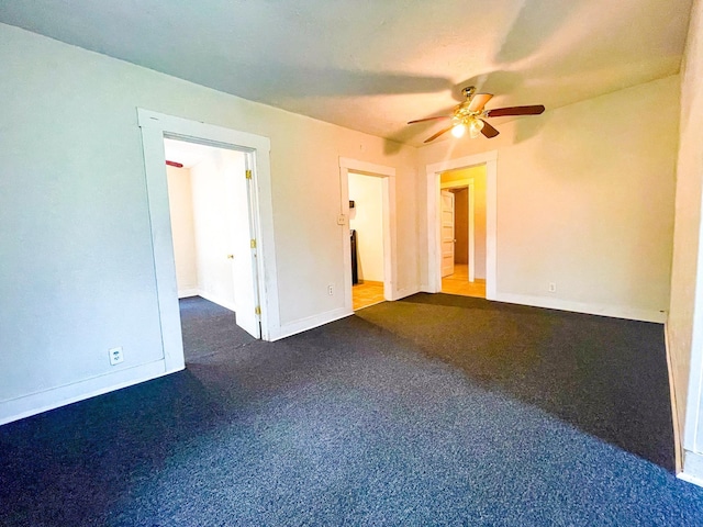 spare room featuring ceiling fan and carpet floors