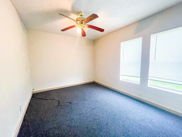 unfurnished room with ceiling fan, carpet, and a textured ceiling