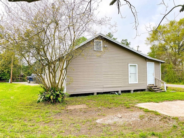 view of property exterior with a yard