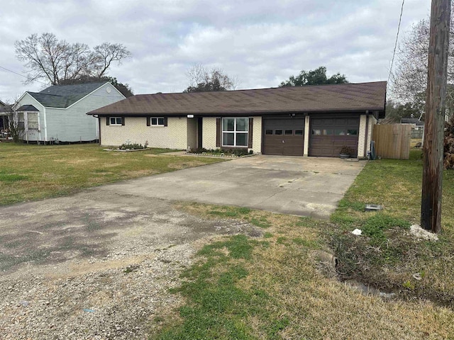 single story home with a garage and a front lawn