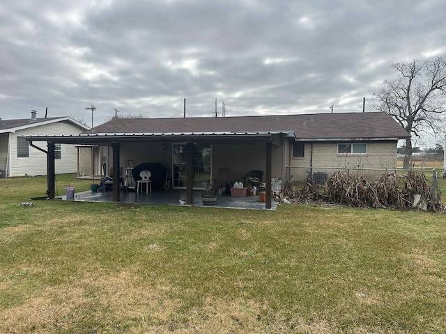 rear view of house with a yard, a pergola, and a patio area